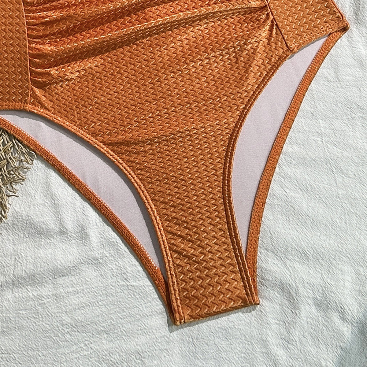 Sienna Texture Halter One-Piece in burnt orange, textured fabric and leg opening detail